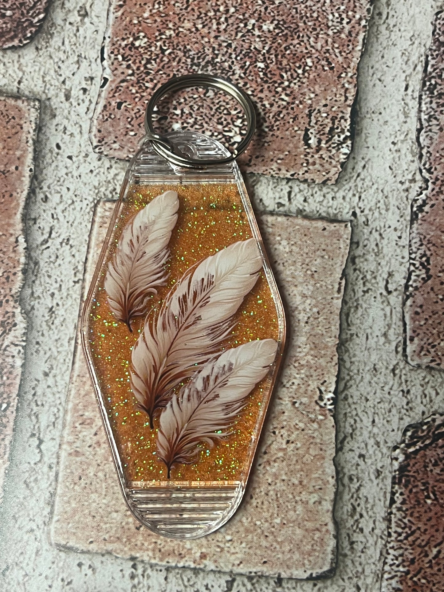 3 feathers motel keychain